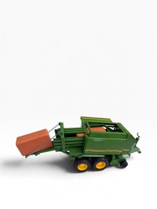 John Deere 690 collectible round baler farm toy with two orange-brown toy hay bales.