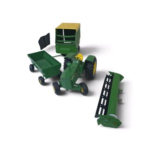 a 116 scale John Deere toy farm set made by Ertl, which includes a green John Deere tractor, a forage wagon with a yellow roof, and a pull-behind implement or harvester