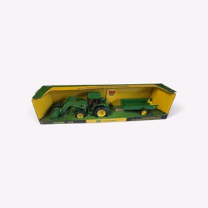 Valued at $175 ERTL 132 scale die-cast John Deere 6210 tractor with a front loader and a manure spreader set in its original window box