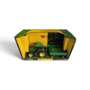 New in Box an ERTL 132 scale John Deere 6410 Tractor with Barge Wagon and Disk toy set in its original yellow and green packaging.