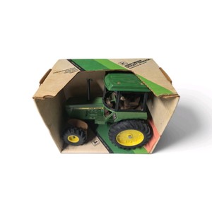 Valued at $80 New in Box vintage 116 scale ERTL John Deere 2550 Utility Tractor (Stock #501) inside its original green-and-white display box