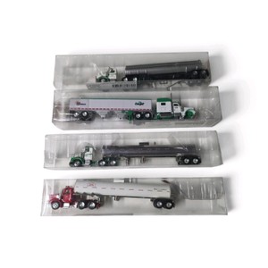 Mega Lot $$$ collection of four die-cast or plastic model semi-truck and trailer sets, including Cargill-branded and commercial tankerhopper truck replicas displayed in clear plastic packaging.