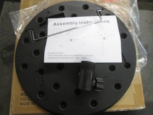 Black plastic table attachment for an umbrella pole