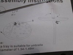 Black plastic table attachment for an umbrella pole