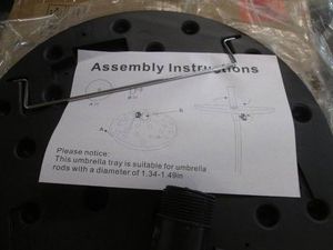 Black plastic table attachment for an umbrella pole