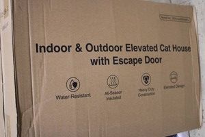 Indooroutdoor elevated cat house with escape door