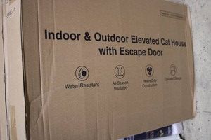 Indooroutdoor elevated cat house with escape door
