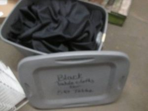 Covered tote of black cloth tablecloths for 5 foot tables