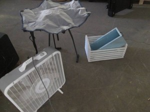 Collapsible camp table, wood holders and an electric fan
