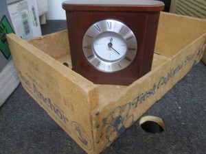 Vintage fruit crate and a desk top clock