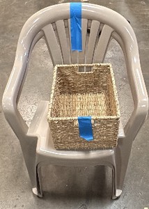 2 plastic chairs and wicker basket
