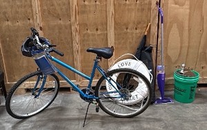 Blue bike, white life preserve, green bucket with items, Cadillac umbrella, swiffer mop, Beckoos foam