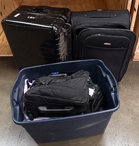 luggage and a tote full of bags