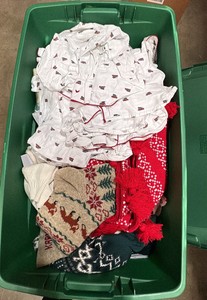 Green tote of christmas clothes