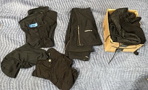 Amazon box of winter clothes, snow pants, face coverings, and shirts