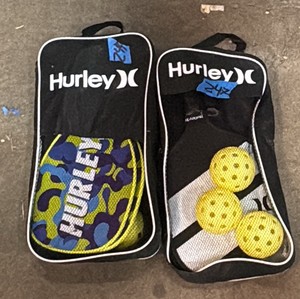 Two pairs of Hurley pickle ball rackets and a few pickle balls