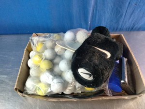 An assortment of used golf balls, wooden golf tees, a ball markerscore caddy tool,
