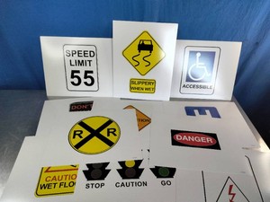 A collection of standard traffic, warning, accessibility, and signal signs