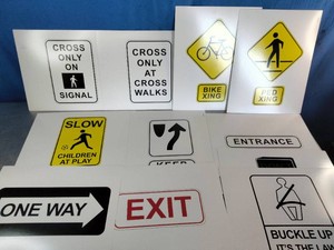 A collection of standard regulatory, warning, and informational traffic signs