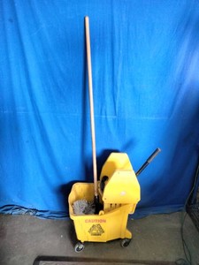 A commercial mop bucket and side-press wringer combination paired with a wooden-handled string mop