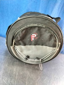 Portable round charcoal grill in a carrying bag