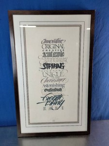 Framed piece features artistic calligraphy and hand-lettering listing descriptive adjectives