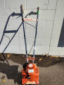 A gas-powered Mantis Mini Tiller  Cultivator