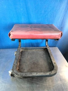 A low-profile mechanics rolling seat or creeper stool with an integrated lower tool tray,