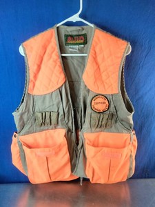 A vintage upland hunting and game vest with blaze-orange quilted shoulders,