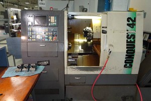 Hardinge Conquest 42 CNC Turning Center with Torit Dryflo and Conveyor