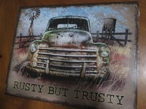 Rusty but trusty metal sign measures 12 x 14 inches