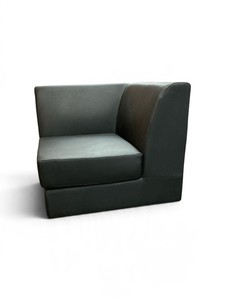 black modular corner lounge chair with an upholstered back and seat,