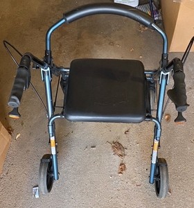 blue four-wheeled rollator walker with a padded seat and a curved backrest