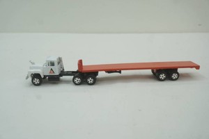 Mac semi tractor with flat bed implement hauling trailer loaded with 2 John Deere tractors 164 scale die cast metal