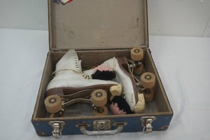vintage  roller skates with real wooden wheels and keys with wrench in a vintage metal case