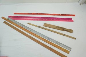group of vintage advertising yard sticks
