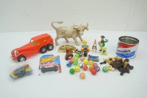 group of vintage toys including a number of bouncy balls, wood farm toys and more