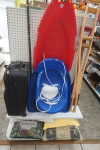 large lot with toboggans, crutches, large pry bar, accent pillows