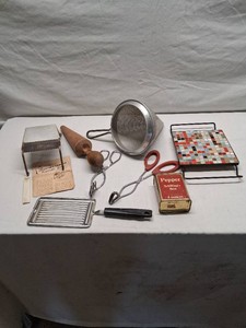 Lot of Vintage Kitchen Items including Schillings Black Pepper Tin, Wear-Ever Strainer, Feemsters Vegetable Slicer, and Mosaic Tile Trivet