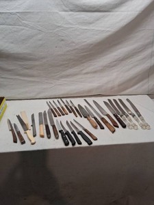 Lot of various kitchen knives and utensils including serrated, carving, and paring knives