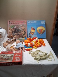 Lot of Vintage Toys and Puzzles Including Jigsaw Puzzles, Dolls, Coin Bank, and Plastic Connectors