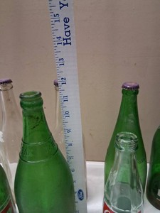 Collection of Vintage Soda Bottles, Including 7-Up and Coca-Cola