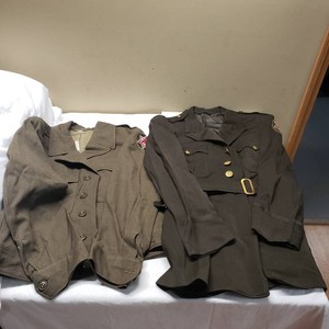 Military uniforms with patched insignia from the 1940s1950s Era