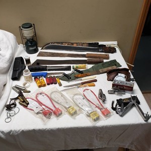 Camping and Hunting Supplies Lot Including Coleman Lantern, Ridge Runner Tools, Ammo, Knives, and Camo Creme