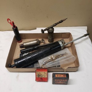 Lot of Automotive Tools and Parts including Grease Guns, Bearings, and Accessories