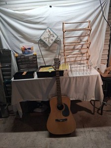 Lot of items including Conqueror Acoustic Guitar, Record Album, Metal Tile Stand, Wooden Drying Rack, and Storage Organizer.