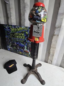 Vintage-style gumball machine filled with toy cars, including Hot Wheels hat.