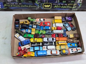 Diecast toy vehicles including brands like Tomica, Zylmex, Playart and Corgi Juniors, featuring a variety of model cars, trucks, and specialty vehicles.