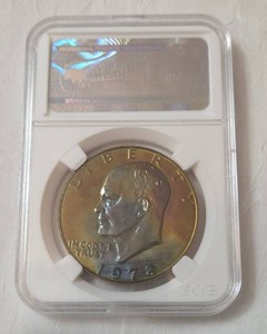 1978 Eisenhower Ike Dollar sealed in a slab featuring vibrant iridescent rainbowmonster toning,