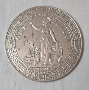 1902 British Trade Dollar,  Features a standing figure of Britannia holding a trident and a Union Jack Shield with a merchant ship in the background. This is a replica.